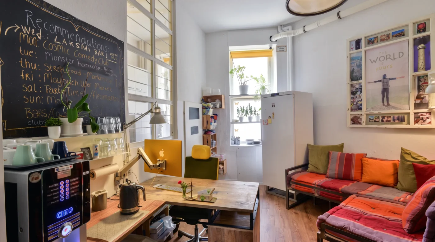 Sitzecke mit Sofas, Tisch und Kaffeemaschine im Kiez Hostel Berlin in Friedrichshain